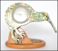 A vintage 20th century mantel clock in the form of a Kiwi bird constructed from abalone raised on