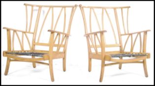 A retro 1950's mid century beech wood sofa and armchairs suite in need of re-upholstery having