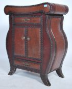 An unusual faux leather vinyl studded drawer cabinet unit having a shaped body with short drawer