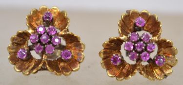 A pair of 18ct gold and pink sapphire adorned ladies earrings in the form of flowers, complete