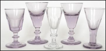 A pair of 18th century Georgian purple tinted wine / dram drinking glasses having trumpet bowls with