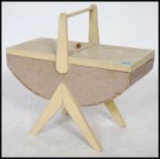 A mid century / 1950's sewing box of painted form raised on to a tapering supports with lozenge