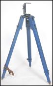 A vintage 20th century industrial tripod base on adjustable legs with original leather straps and