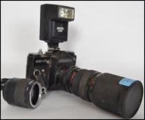 A vintage mid 20th century Zenit 35mm camera and lenses together with a vintage film viewer.