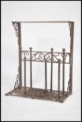 A 20th century cast metal Coalbrookedale style boot scrape / boot holder having storage for four