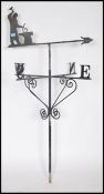 A large cast metal weather vane being ebonised wit