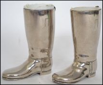 A pair of 20th century silver plated boot measures for spirits. Complete with the white inner