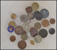 A collection of vintage coins and tokens from around the world dating from the 18th century to
