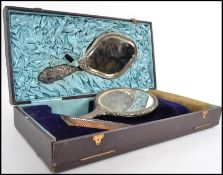 A silver hallmarked cased ladies vanity brush set by Walker & Hall. The harlequin set to include