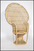 A vintage 20th century cane wicker rattan weave conservatory chair, having a peacock fan back with