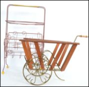 A retro 20th century 1950s magazine rack with sides formed as a music stave with treble clef and