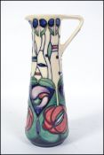 A Moorcroft tall jug, tubelined decorated in the Charles Rennie Mackintosh Tribute pattern, signed