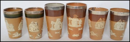 A ;collection of Royal Doulton stoneware harvest ware silver hallmarked collared beakers.