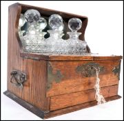 A Victorian golden and white metal bound 3 piece tantalus compendium. The glass decanters in