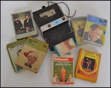 A vintage 8 track player complete with many cassettes to include Paul Robeson, Bing Crosby, Jim