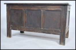 A large 18th century country oak coffer - blanket box chest being raised on tall stile supports with