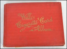 A good Wills Cigarette Card Album in red with tooled gilded notation to include cards from Hignett's