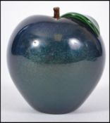 A 20th century Orient & Flume glass paperweight in the form of an apple having a pearlescent blue