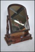 A large 19th century Victorian toilet swing mirror being raised on a serpentine base with large