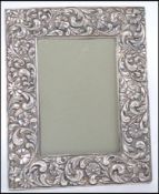 A silver hallmarked photograph frame with glass front and easel back