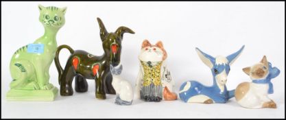 A group of ceramic cats and donkeys to include Rye Monastery cat, Kilkenny cat, Szeilfr cat, Royal