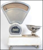 A good set of vintage Avery Industrial grocers scales in white enamel with large triangular dial