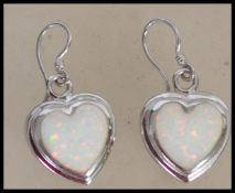 A pair of ladies contemporary silver and opal adorned earrings of heart shape complete in the