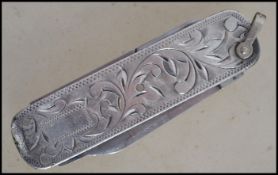 A sterling silver Japanese pen knife and scissors set having a rococo leaf swirl design. Weighs 29.2