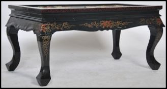 A mid century Chinese ebonised folding coffee table adorned and inset with soapstone and agate