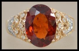 A yellow metal gold ladies ring set with a large ce