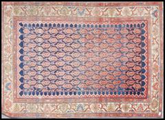 A 19th century Persian rug with central panel of Boteh's on blue ground with geometric panel borders