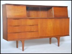 A vintage mid 20th century teak sideboard / credenza, three drawers left with bi fold cupboard
