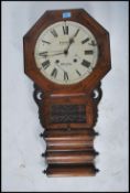 A Victorian mahogany and marquetry inlaid drop dial wall clock with glass pendulum window, the