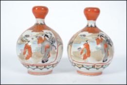 A pair of 19th century Oriental Kutani baluster vases with waisted necks having geometric borders