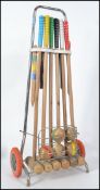 A retro 1980's children's croquet lawn set complete with balls, within the original wheeled carrying