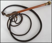 A good believed early 20th century Australian snake whip. The malacca shaft adorned with large