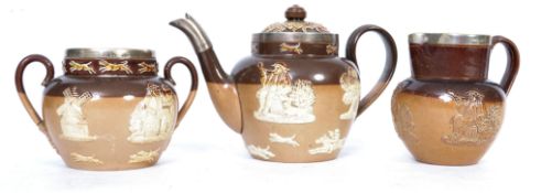 A Doulton Lambeth three piece silver mounted stone wear glazed tea service consisting of teapot,