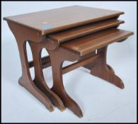 A retro 20th century vintage teak wood effect nest of tables by Valco having shaped legs united by