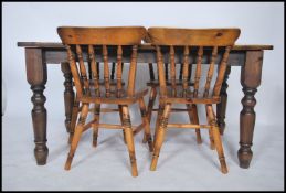 A Victorian style country solid pine dining table together with a matched set of pine dining chairs,