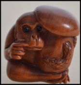 An unusual carved hardwood Chinese figure of a monkey and a mushroom being signed to the base (