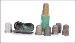 An unusual early 20th century cased pair of thimbles, the case in the form of binoculars together
