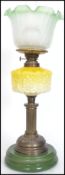 Late 19th Century brass double burner oil lamp with repousse yellow on milk glass glass reservoir on