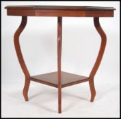 An Edwardian mahogany and marquetry inlaid centre table of octagonal form and raised on serpentine
