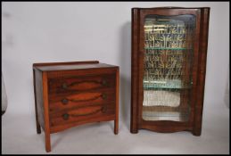 A 1930's Art Deco walnut display cabinet of square form with full length door and mirror lined