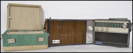 A vintage mid century retro HMV portable radio with teak facia together with a 1950's Transistor