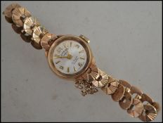A hallmarked 9ct Rotary gold cocktail watch with Art Deco style scalloped 9ct gold strap. Hallmarked