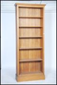 A large contemporary solid oak ( oak furniture land style) open window tall bookcase being raised on
