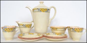 A 1930's Art Deco Newhall pottery tea service in a chintz pattern comprising teapot. cups,