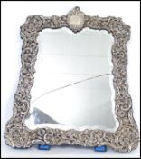 A stunning Edwardian large silver hallmarked rectangular easel mirror. The mirror of rococo form