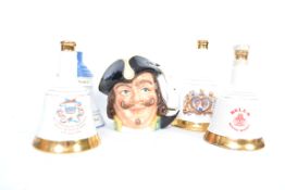 A collection of commemorative collectors Wade Bells Whisky bottles / Decanters to include Charles